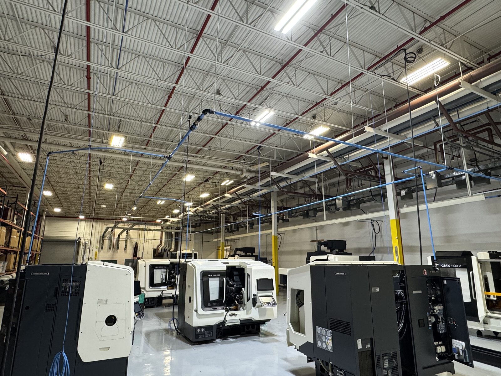 Modular aluminum compressed air mains and branch lines over DMG MORI CNC machines - air line piping Tampa FL